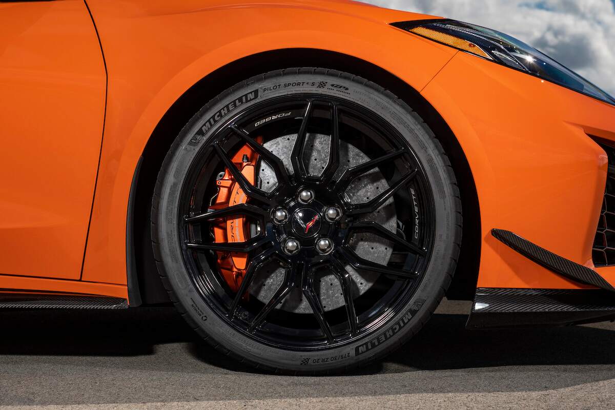 A close up of the wheel of an orange 2023 Chevrolet Corvette, one of the best Chevrolet models.
