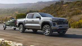 The 2023 Chevy Colorado towing a jetski down the road
