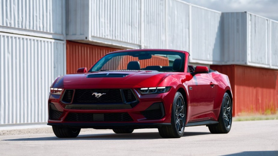 Red 2023 Ford Mustang GT Convertible in front of an industrial building