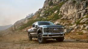 A 2023 Ford Super Duty F-250 driving in a rocky mountainous area. The F-250 is one of the best heavy duty trucks to buy.