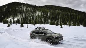 The 2023 Subaru Forester in green showing off its winter weather strengths.