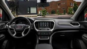 Interior front row view of a 2023 Acadia SLT midsize SUV model window visibility