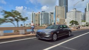 A 2023 Genesis G90 driving down the road.