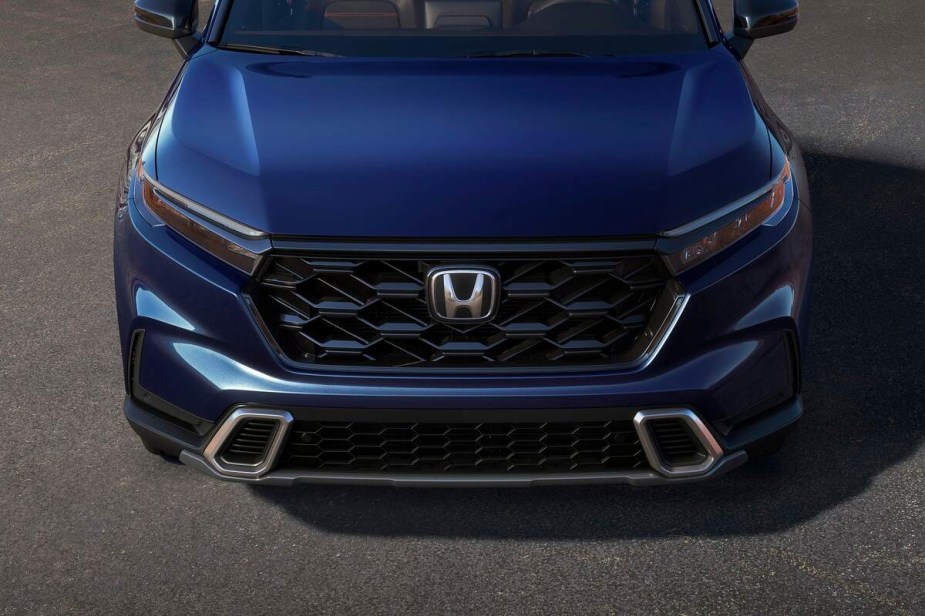 A blue 2023 Honda CR-V parked on a blacktop ground. 
