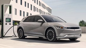 A gray 2023 Hyundai Ioniq 5 small electric SUV is charging.