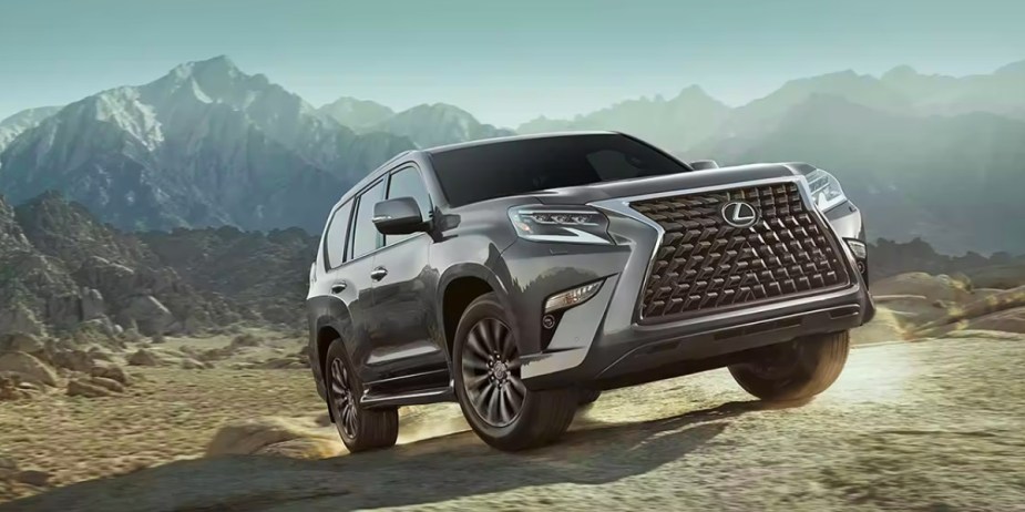A gray 2023 Lexus GX full-size SUV is driving off-road. 