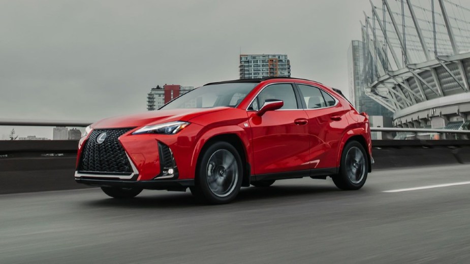 Red 2023 Lexus UX 250h Driving on a road