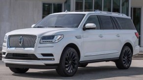 2023 Lincoln Navigator Posed next to an office building - This is the best 3 row SUV for legroom