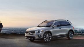 A gray 2023 Mercedes-Benz GLB-Class compact luxury SUV model parked overlooking a city of night lights