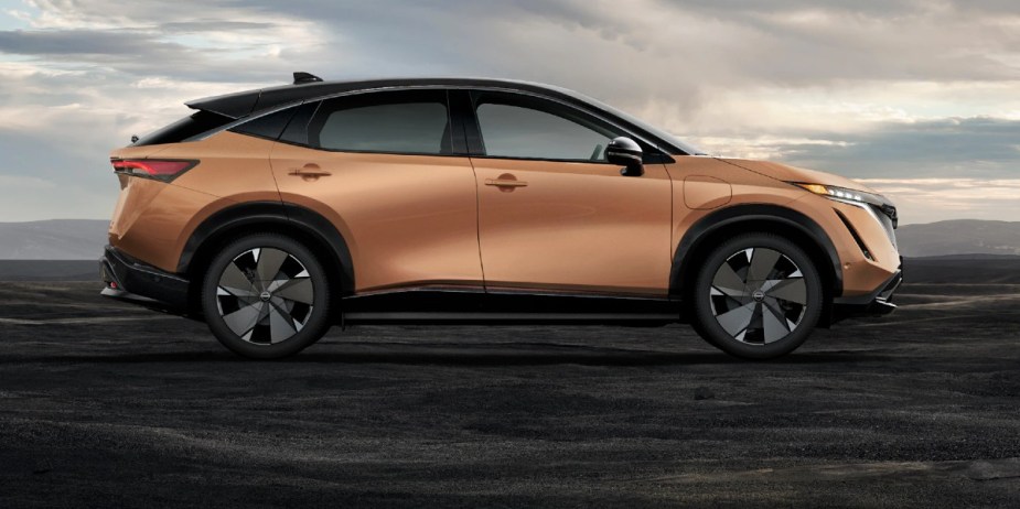 A copper 2023 Nissan Ariya small electric SUV is parked. 