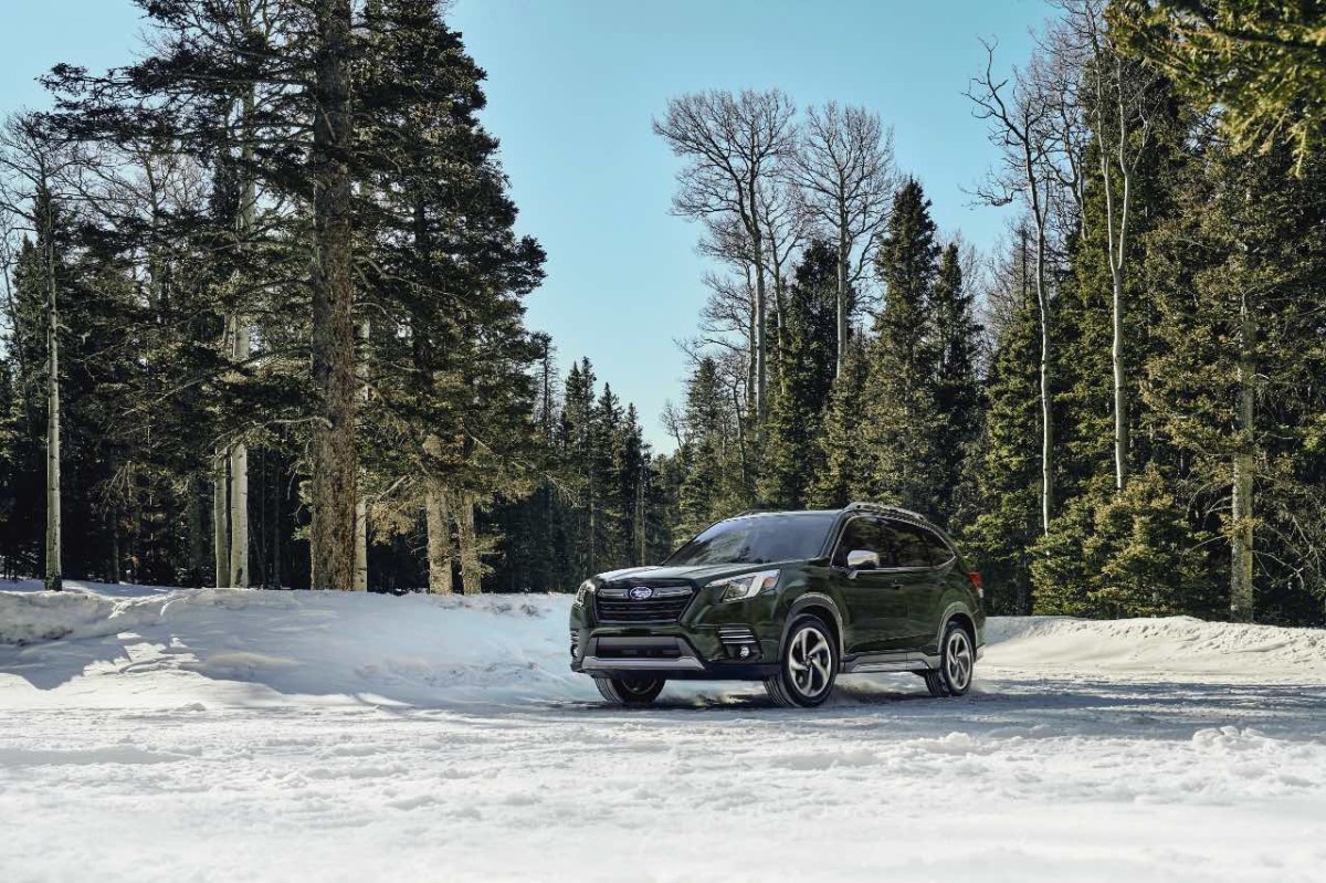 A green 2023 Subaru Forester – an alternative to the 2023 Toyota RAV4 – driving in snow 