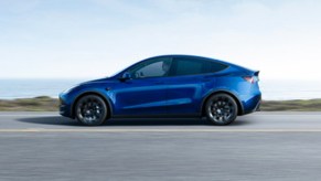 A blue 2023 Tesla Model Y small electric SUV is driving on the road. The only Tesla Top Safety Pick this year is the Model Y.