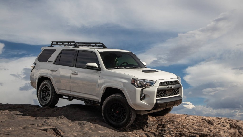 2023 Toyota 4Runner on a Rocky Ledge with clouds in the background - This is the most reliable midsize SUV according to iSeeCars