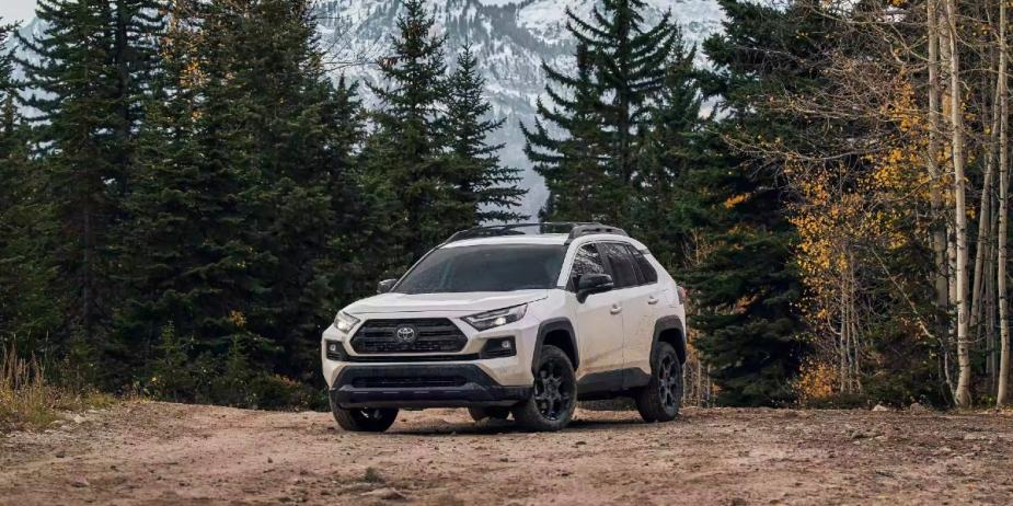 A white 2023 Toyota RAV4 small SUV is parked outside. 