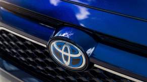 A blue 2023 Toyota RAV4 Prime grille with the Toyota logo. The RAV4 Prime is one of the top Toyota vehicles.