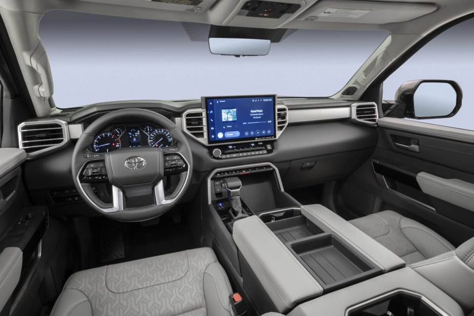 The interior of a Toyota Tundra with both an infotainment screen and digital gauge cluster.