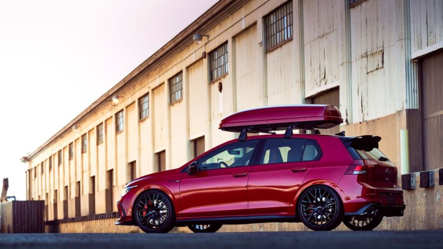 A red 2023 Volkswagen Golf GTI sport hatchback 'hot hatch' model with roof cargo carrier