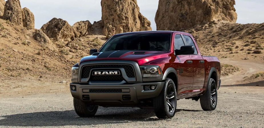 A red Ram 1500 Classic Warlock sits in a remote area as a full-size truck.