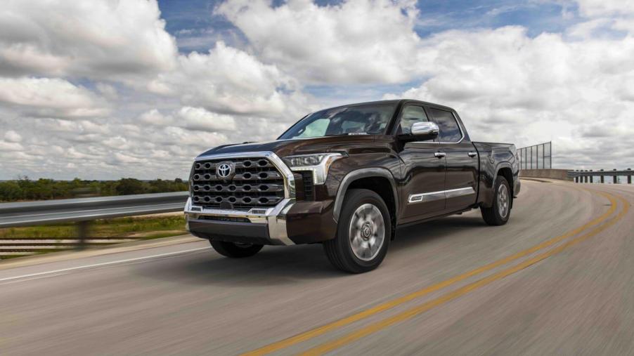 A brown 2023 Toyota Tundra pickup truck driving down the highway.