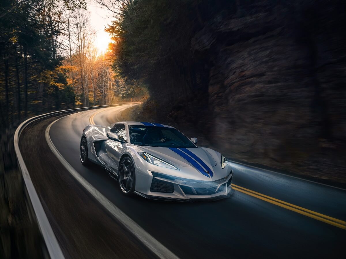 A new hybrid 2023 Chevrolet Corvette E-Ray in blue and silver takes a corner. 