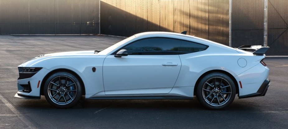 A new 2024 Ford Mustang Dark Horse shows off its white paintwork and side profile. 