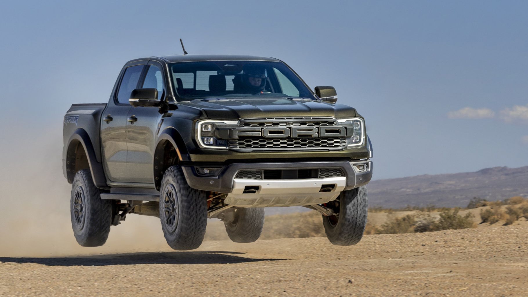 The 2024 Ford Ranger Raptor jumping through the air. This is the base for the truck Ford is sending to compete in Dakar 2024.