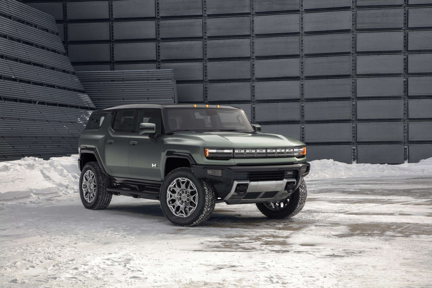 The 2024 GMC Hummer EV SUV parked in the snow