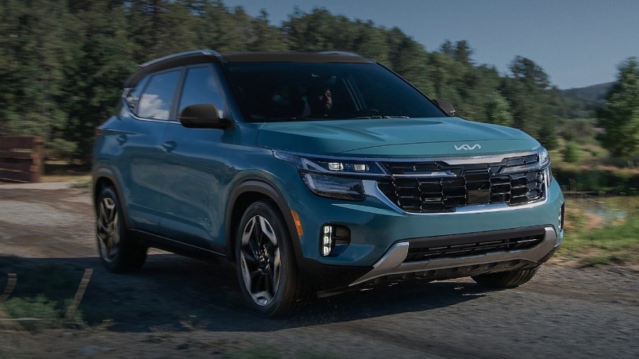 A blue 2024 Kia Seltos subcompact SUV is parked.