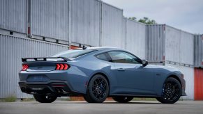 A blue 2024 Ford Mustang GT shows off its new looks and spoiler.