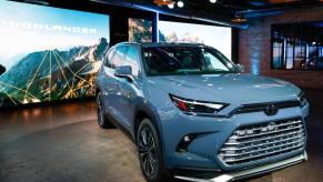 A blue 2024 Toyota Grand Highlander SUV is displayed at the Chicago Auto Show.
