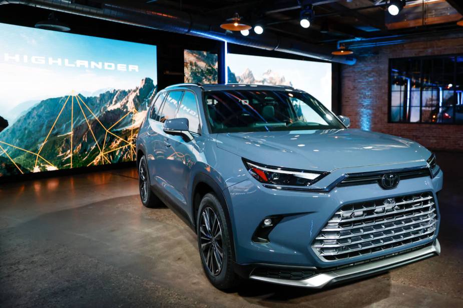 A blue 2024 Toyota Grand Highlander SUV is displayed at the Chicago Auto Show.