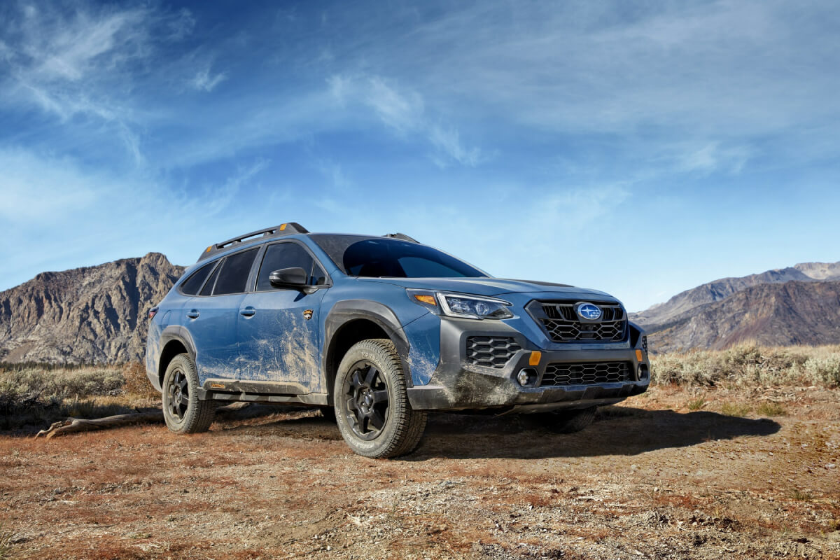 A 2024 Subaru Outback Wilderness drives off-road in the desert.
