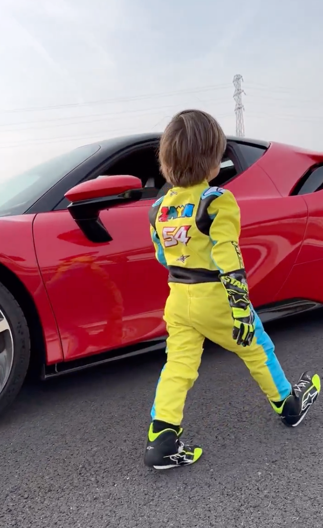 3-year-old walking up to a red Ferrari SF90