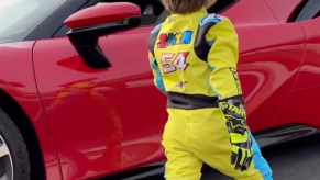 3-year-old walking up to a red Ferrari SF90