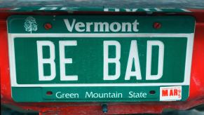 A green Vermont vanity license plate that says "Be Bad"
