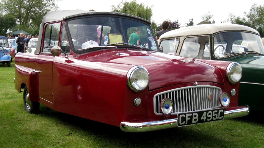 Red 1964 Bond Microcar posed at a car show