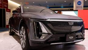 A dark color Cadillac Lyriq parked indoors.