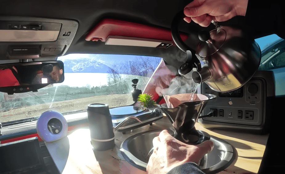 making coffee in the Chevrolet Camaro tiny camper