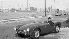 Carroll Shelby sits in a Cobra, a car that he turned into a Super Snake later in life.