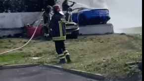 A blue Ferrari Berlinetta on fire after crashing into an Italian villa.