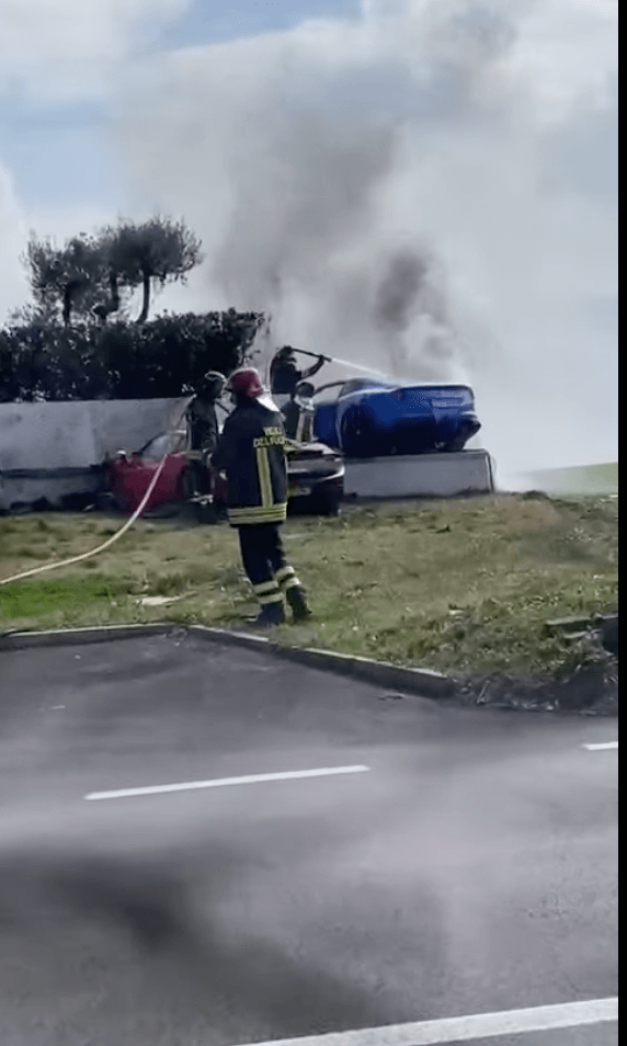A blue Ferrari Berlinetta on fire after crashing into an Italian villa.
