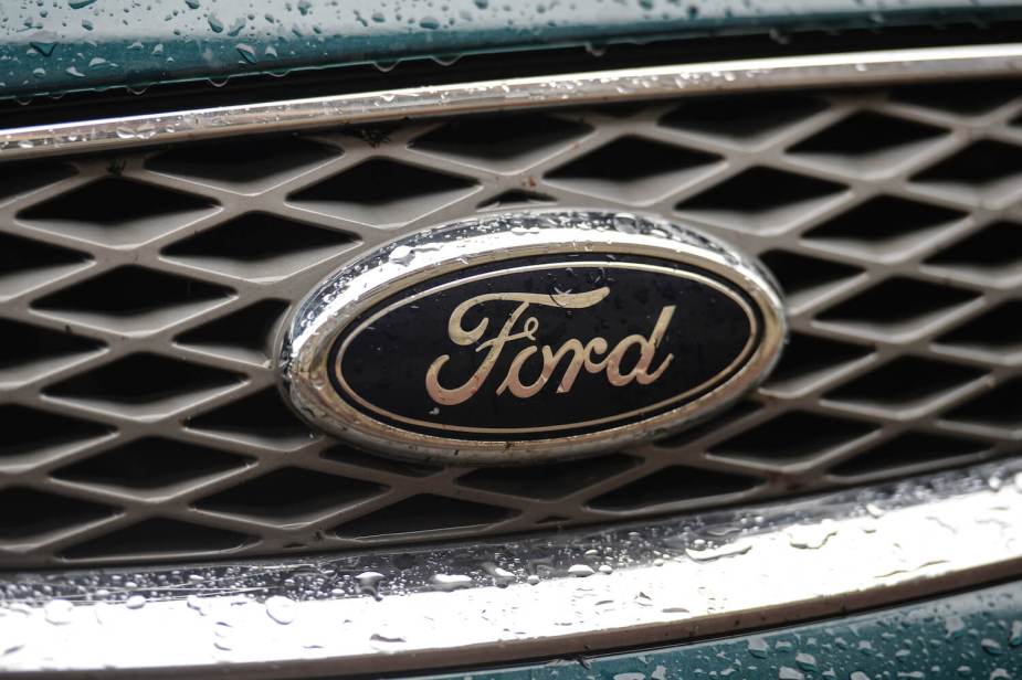 Closeup of the logo of Ford on the grille of a vehicle.