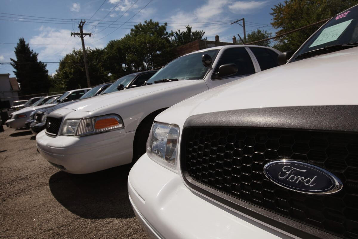 A line of Ford Crown Victoria models in a used car lot in Chicago, Illinois