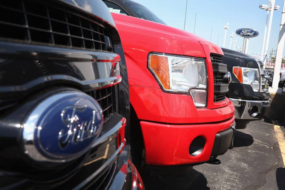 A row of new 12th generation (2013) Ford F-150 pickup trucks parked at a dealership in Illinois.