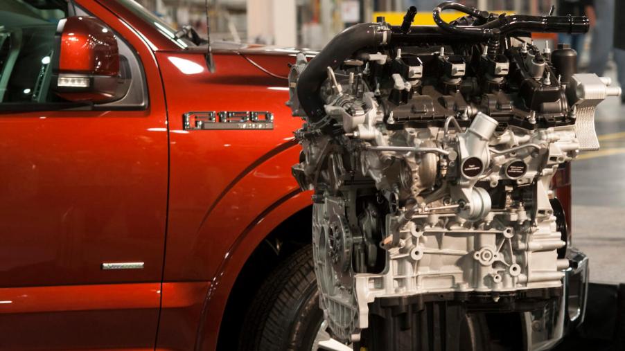A new Ford Motor Co. 2.7 liter EcoBoost V6 engine sits on display with a F-150 truck during an event at the company's Engine Plant in Lima, Ohio, U.S. on Friday, March 28, 2014.