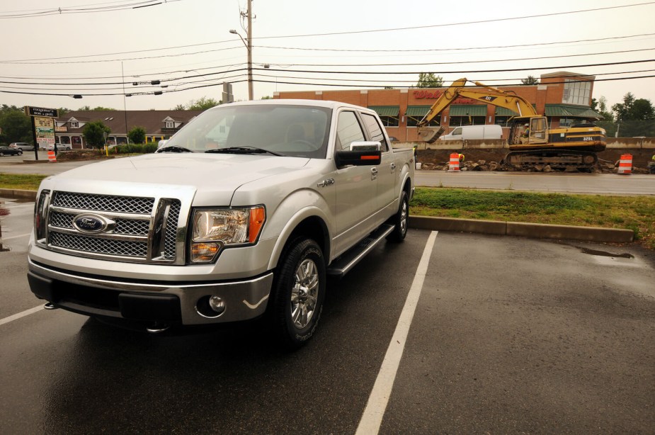 A silver F-150 in a parking lot, a construction site visible in the background.