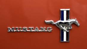 Ford Mustang logo on an orange car.
