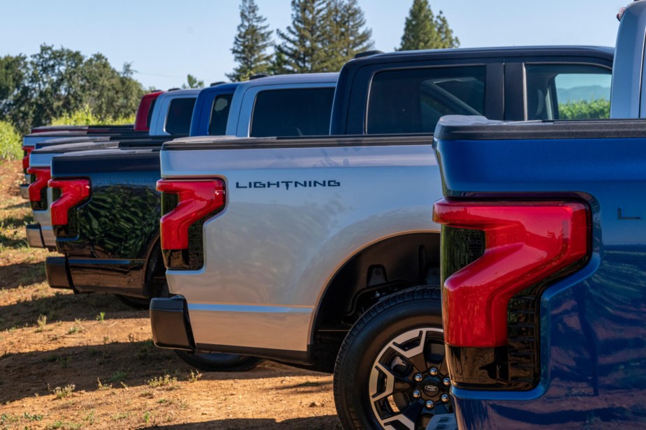 Layered shot of multiple Ford F-150 Lightning EV truck beds. 