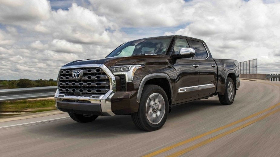 A brown 2023 Toyota Tundra full-size truck is driving down the road, it is currently facing a recall.