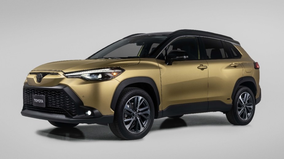 Front angle view of gold 2023 Toyota Corolla Cross Hybrid crossover SUV